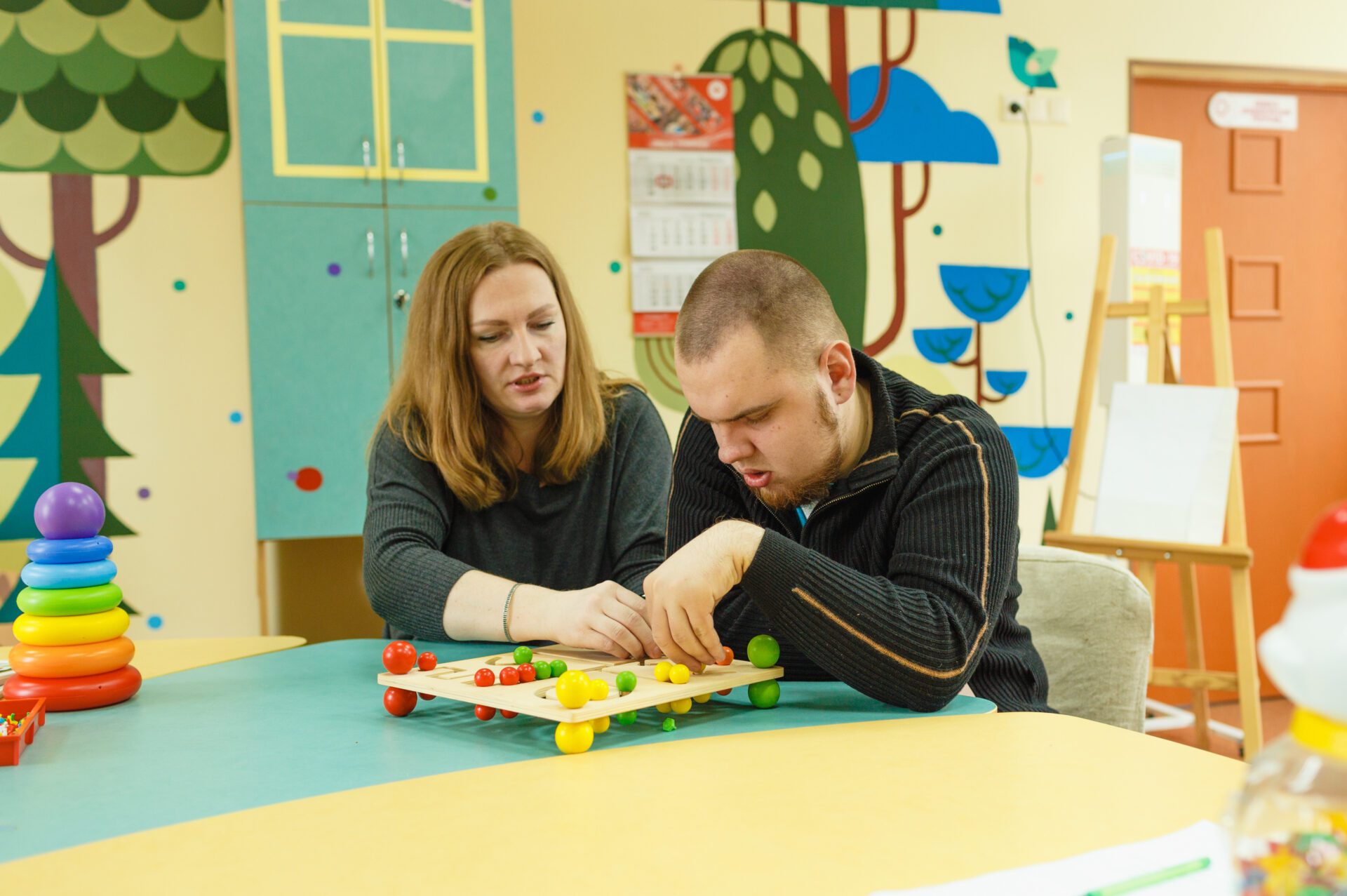 a psychologist is engaged with an autistic man with mental disabilities